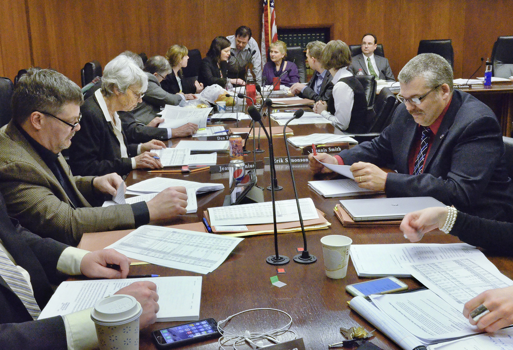 Members of the House Job Growth and Energy Affordability Policy and Finance Committee look through the committee omnibus bill during and April 8 walk-through. Photo by Andrew VonBank